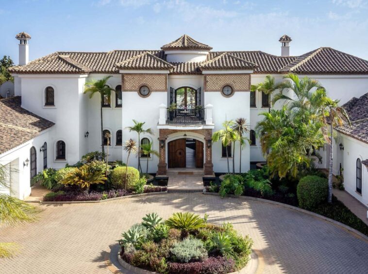 Stunning facade of an authentic Andalusian villa with breathtaking sea views, showcasing traditional architectural elements such as terracotta tiles, ornate detailing, and arched windows, blending timeless Andalusian charm with panoramic views of the ocean.