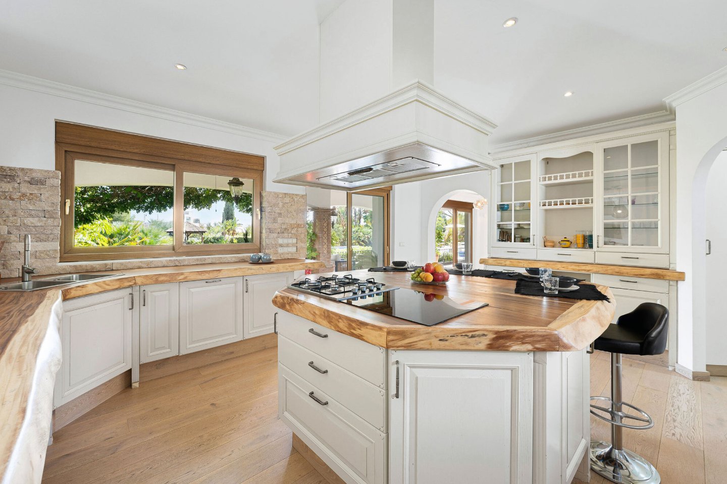 Charming kitchen in an authentic Andalusian villa with breathtaking sea views, featuring traditional Andalusian design elements, modern appliances, and rustic details that create a warm and inviting space for cooking and dining with a scenic backdrop.