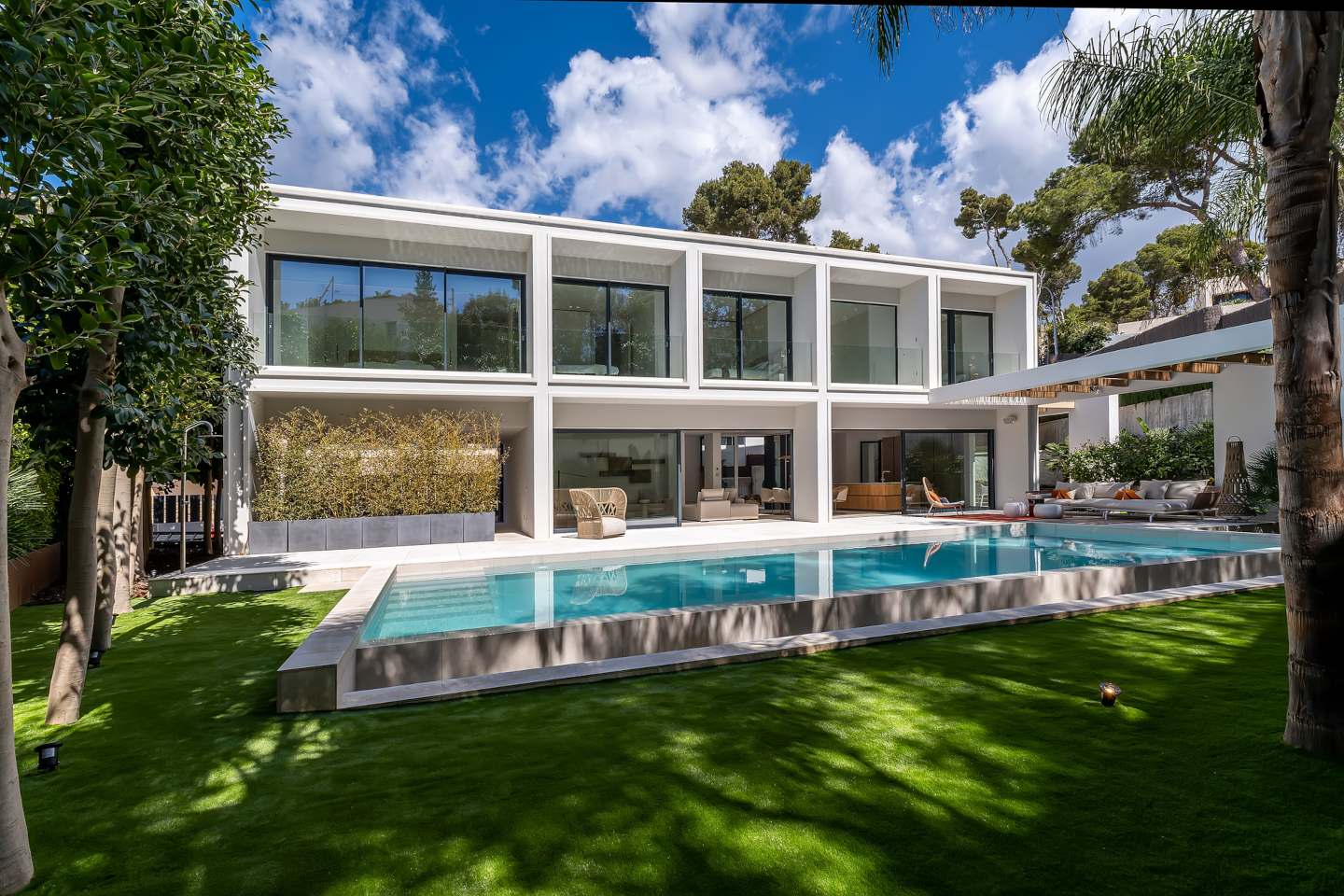 Luxurious infinity pool at a contemporary beachside villa in Bendinat, Mallorca, surrounded by sleek modern architecture and offering breathtaking panoramic sea views for the ultimate coastal retreat.