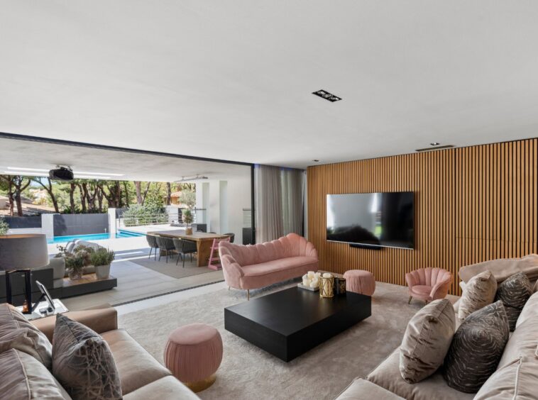 Sophisticated bedroom in an elegant villa in Marbella East, featuring modern furnishings, large windows with views of lush greenery, and a serene, spacious design that combines luxury and comfort for a peaceful retreat.