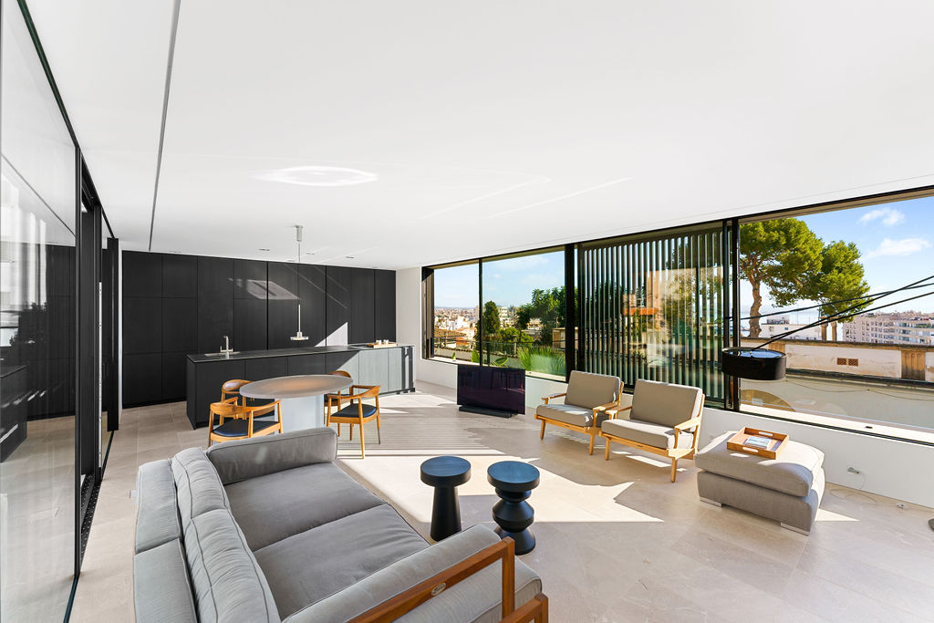 Elegant living room in an elevated sea view villa in Palma de Mallorca, featuring modern decor, large windows, and spectacular ocean views.