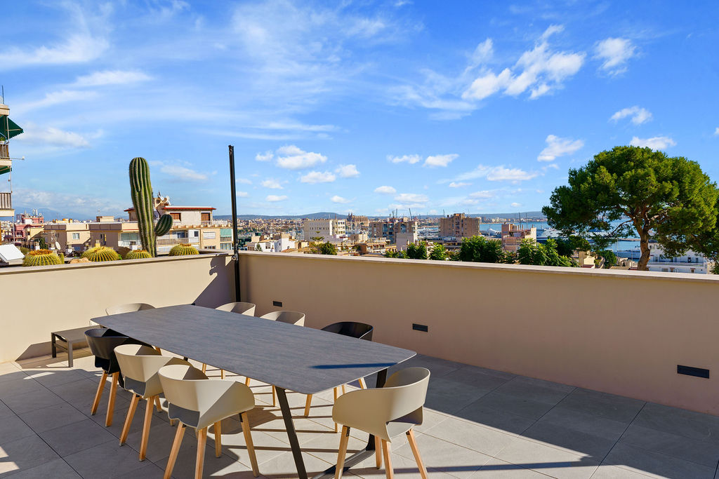 Stunning solarium in an elevated sea view villa in Palma de Mallorca, offering panoramic views of the sea and a stylish outdoor lounging area.