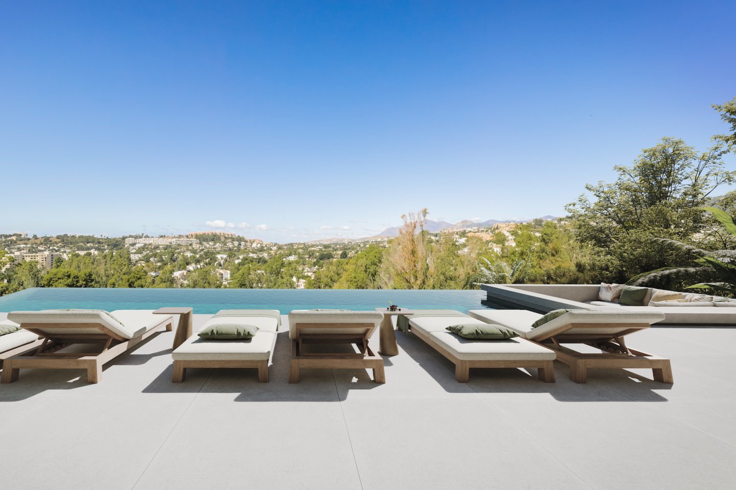 Breathtaking infinity pool of a new build villa in El Herrojo, Benahavis, seamlessly blending with the horizon and offering stunning views of the surrounding landscape. The pool's sleek design enhances the villa's luxurious and modern aesthetic, creating a serene and picturesque setting for relaxation.