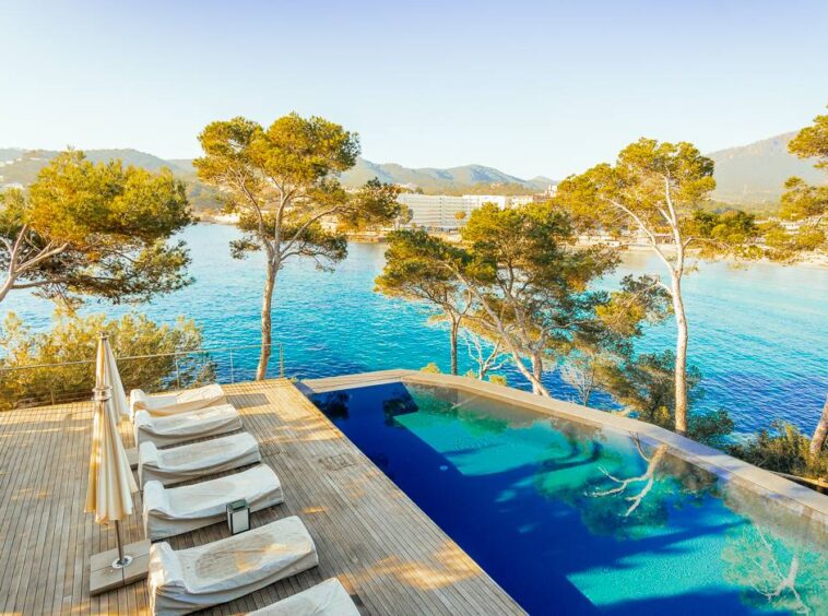 Breathtaking view from a seafront luxury villa in Camp de Mar, Mallorca, showcasing a stunning terrace that extends over the sea, with panoramic ocean views and a perfect blend of natural beauty and modern architecture.