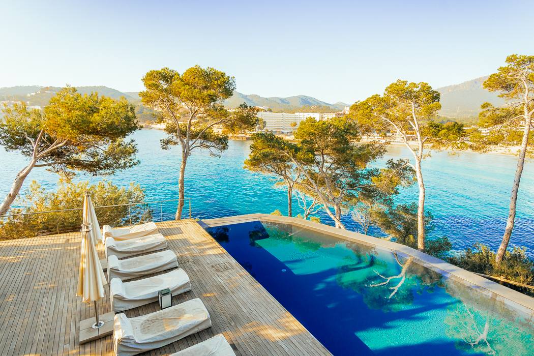 Breathtaking view from a seafront luxury villa in Camp de Mar, Mallorca, showcasing a stunning terrace that extends over the sea, with panoramic ocean views and a perfect blend of natural beauty and modern architecture.