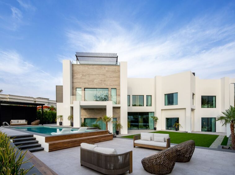 Stunning facade of an ultra-luxury mansion in Emirates Hills, showcasing elegant architecture and breathtaking skyline views