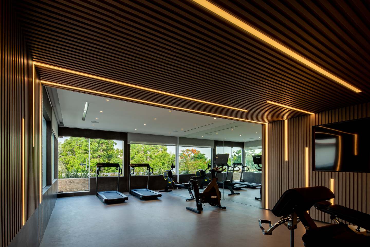 State-of-the-art gym in an ultra-luxury mansion in Emirates Hills, featuring modern fitness equipment and breathtaking skyline views.